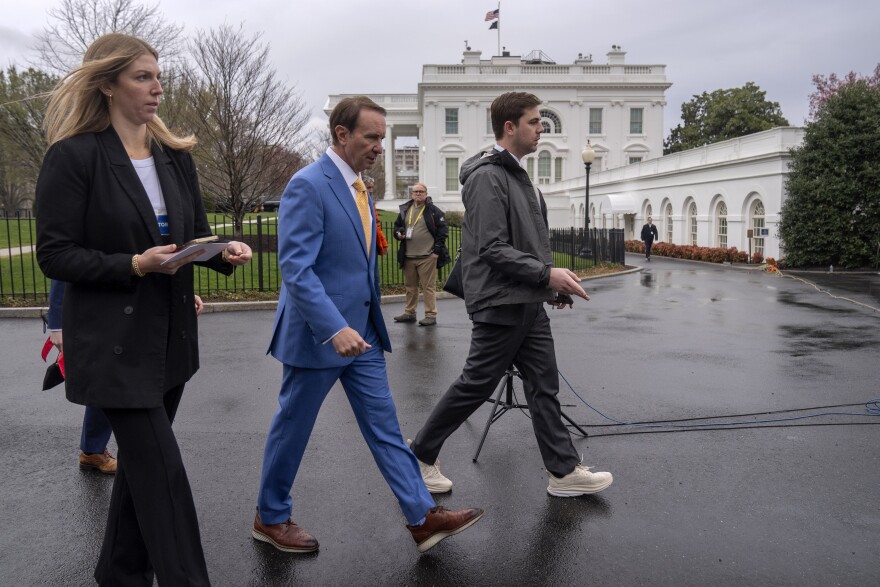 Louisiana Gov. Jeff Landry, center, walks outside the White House, Monday, March 24, 2025, in Washington. (AP Photo/Mark Schiefelbein)