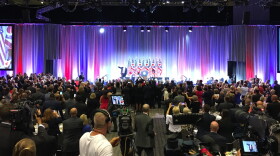 President Donald Trump leaves the stage as the crowd applauds. 