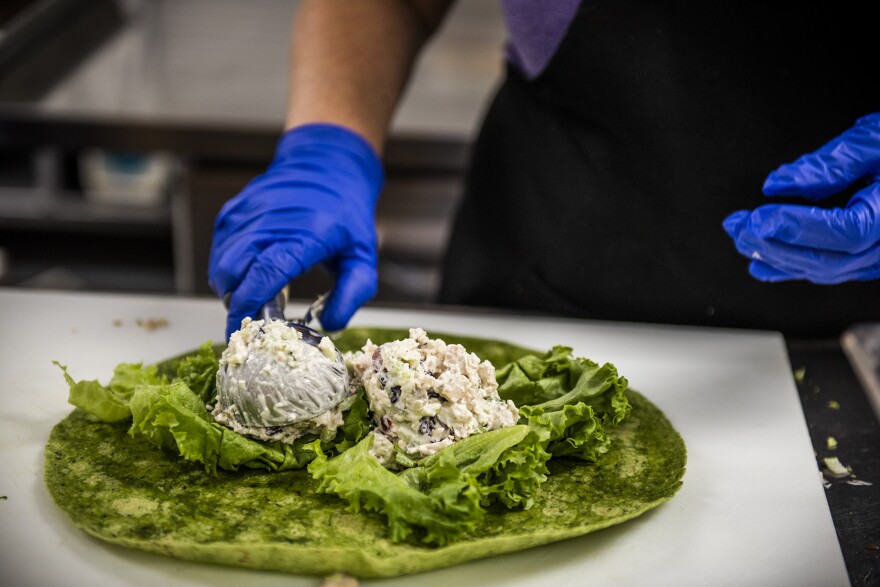 Two generous scoops of turkey salad go onto a lettuce leaf and a spinach tortilla the Turkey Salad Wrap for today’s Farm Fresh Fridays lunch.