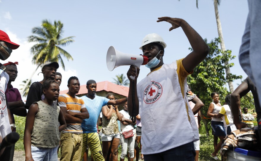 Workers with UNICEF and the Haitian Red Cross prepare to distribute relief supplies in Torbeck, Haiti.
