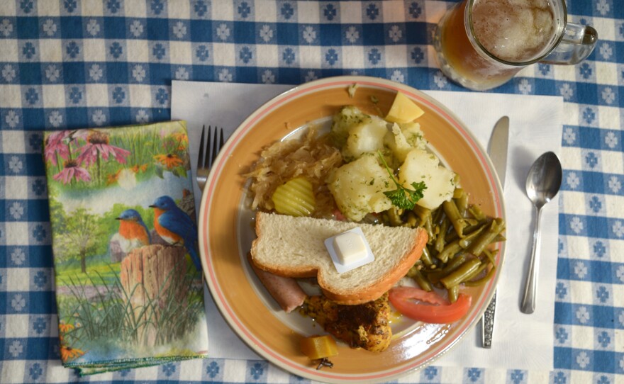 The sampler plate at the Hutte Restaurant included parsley potatoes, sauerkraut, bratwurst, green beans, curried chicken, bread and a chunk of Swiss cheese.