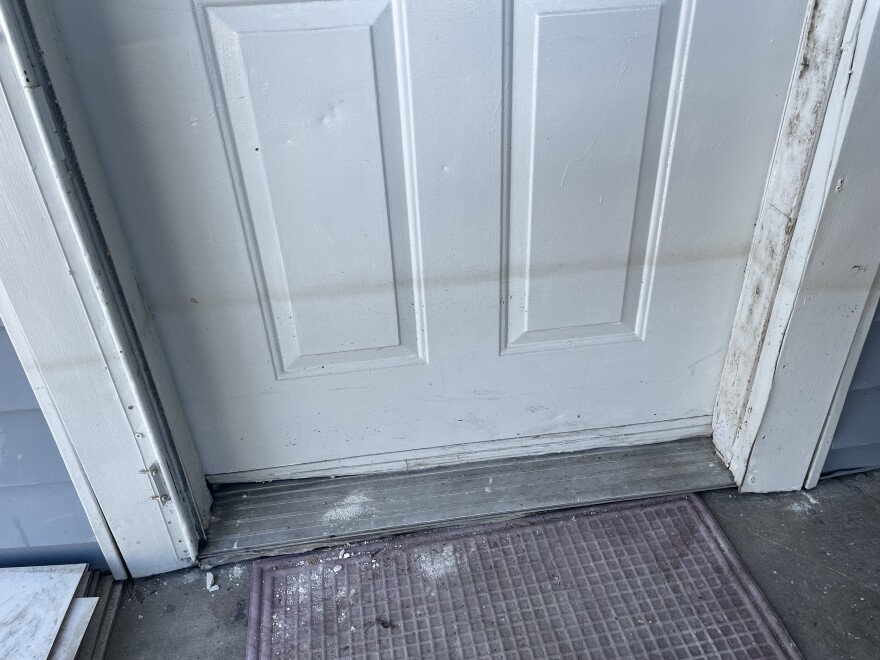 White front door with a gray line at knee-height to show how high floodwaters got.