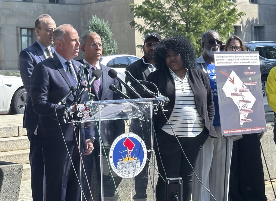 Brian Schwalb, attorney general for the District of Columbia, center left, and Maryland Attorney General Anthony Brown, to his right, speak outside the federal courthouse, Tuesday, Sept. 3, 2024 in Washington. Three gun shops that sold dozens of firearms to a man who trafficked the weapons in and around Washington, D.C., are facing a new lawsuit filed jointly Tuesday by attorneys general for Maryland and the nation’s capital. (AP Photo/Lindsay Whitehurst)