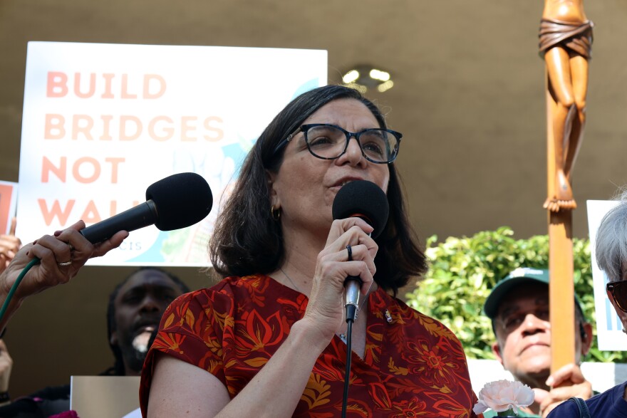 Ellie Hidalgo, co-director of the Catholic women's leadership group Discerning Deacons, speaks at a prayer vigil outside of Miami's federal immigration court in honor of 25 detainees who died in ICE custody Nov. 13, 2025.
