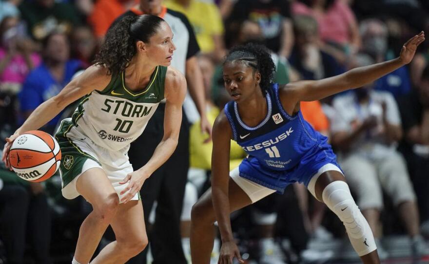 Seattle Storm guard Sue Bird (10) is defended by Connecticut Sun guard Nia Clouden (11) during the second half of the WNBA basketball game Thursday, July 28, 2022, in Uncasville, Conn. (AP Photo/Bryan Woolston)