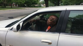 Indianapolis City-County Councilor William Oliver demonstrated reaching for a cell phone and registration in his car during a press conference outside his home.