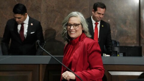 Arizona Democratic Gov. Katie Hobbs arrives at the podium to give her State of the State address in the House of Representatives at the Capitol with Speaker of the House Rep. Steve Montenegro, R-Litchfield Park, left, and Senate President Warren Petersen, R-Gilbert, flanking the governor, Monday, Jan. 12, 2026, in Phoenix.