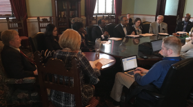 Senate Democrats sit around table talking to reporters