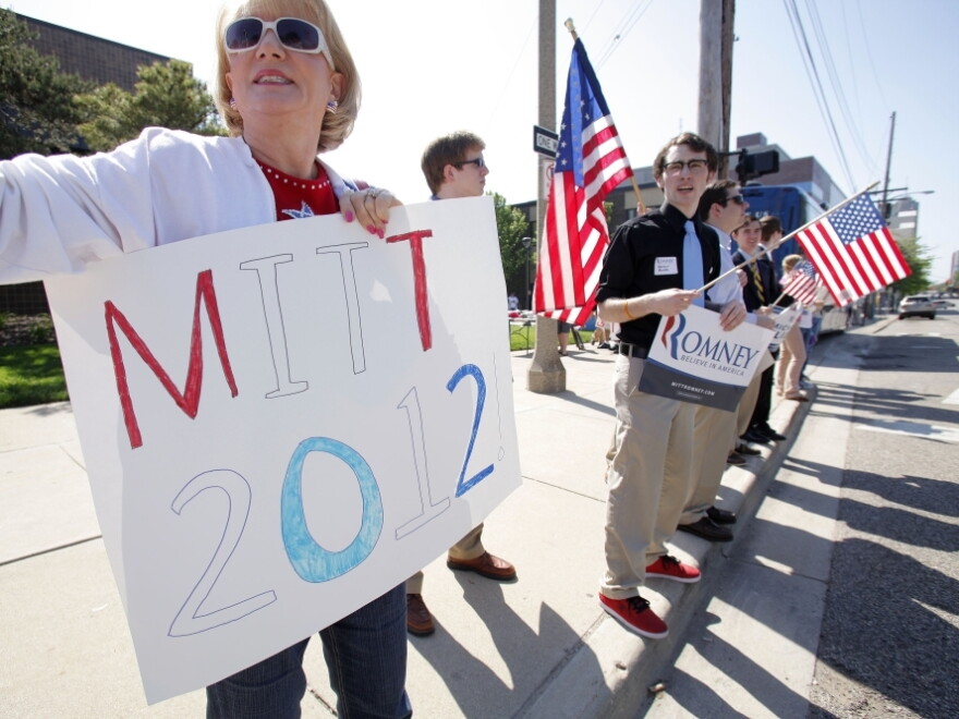 Supporters cheer at passing cars outside the venue as Republican presidential candidate Mitt Romney speaks at a campaign stop at Lansing Community College May 8, 2012 in Lansing, Michigan.
