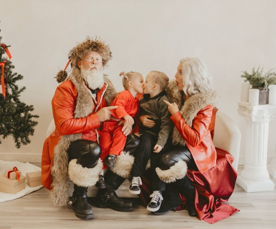 Children sit on the laps of Santa and Mrs. Claus, aka Jeff and Tami Gray