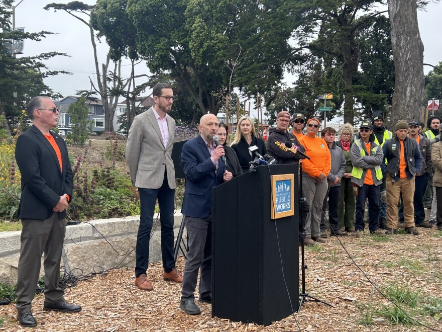 Joel Engardio addresses a crowd in the Sunset announcing new funding.