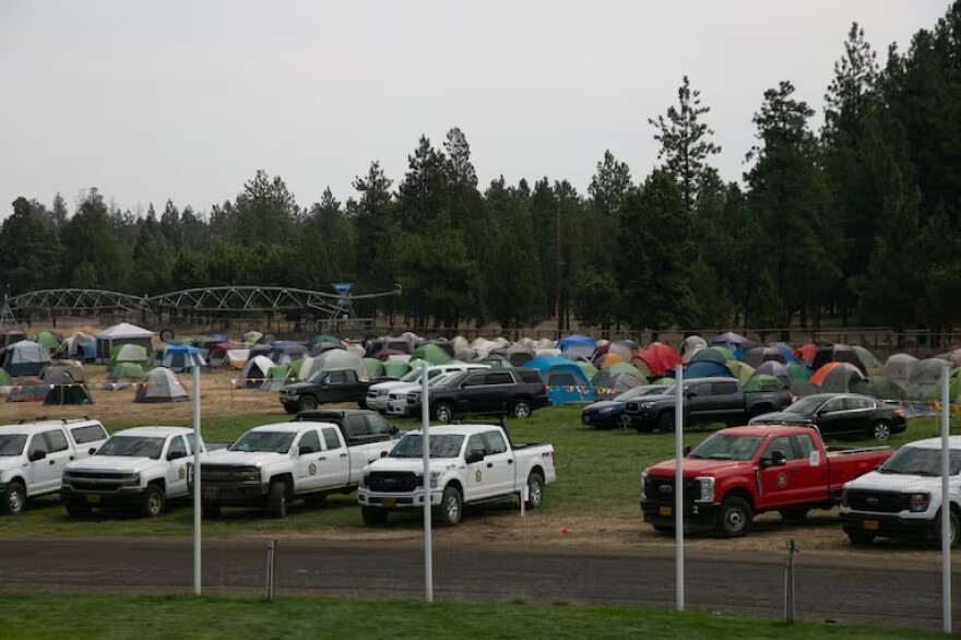 A smoke-blanketed fire camp to coordinate efforts to contain the Flat Fire takes over the Sisters Rodeo Grounds on Aug. 24, 2025.
