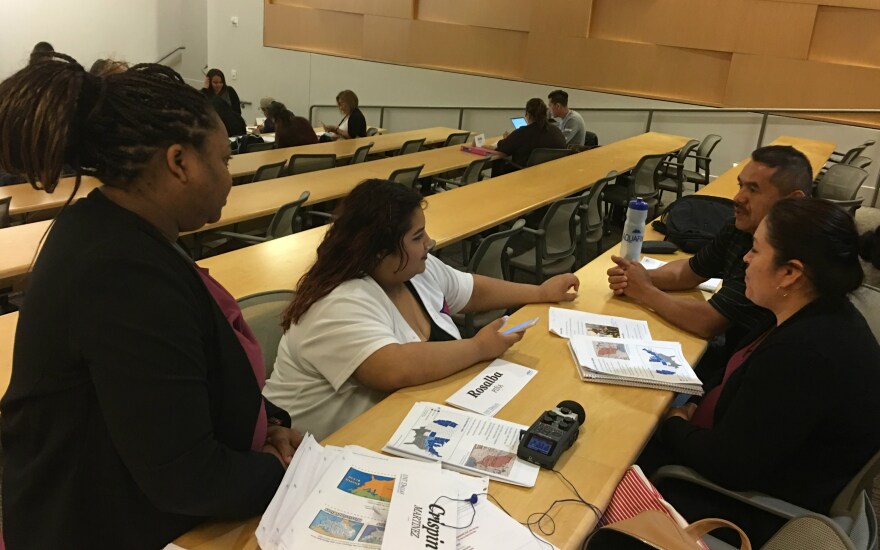 La Tavia Pearl and Lizbeth Munoz (on left) are UNT Dallas students helping teach local residents how to take the U.S. citizenship test so they pass it. That's required for them to become legal U.S. citizens.