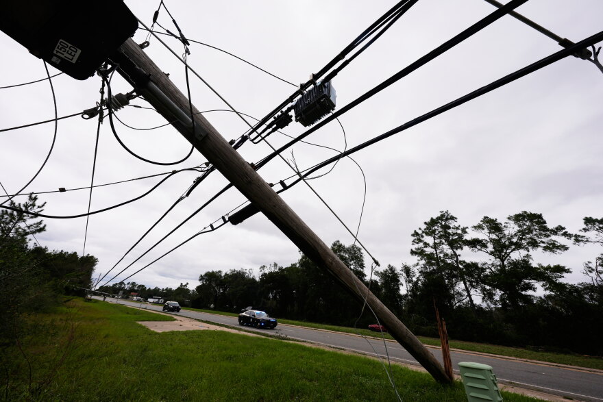 State troopers ride past downed power lines in the aftermath of Hurricane Isaias in Milton, Fla., Saturday, Oct. 10, 2026. (AP Photo/Gerald Herbert)