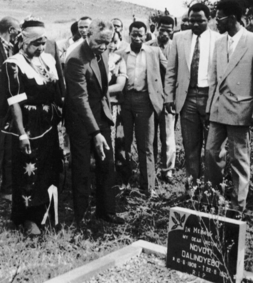 Mandela, who was then deputy president of the African National Congress, accompanied by his then-wife Winnie, visits his family grave in Qunu, on April 26, 1990.