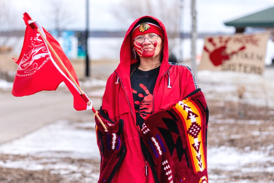 Lori Ah-shein holds a MMIW flag at the eighth annual Missing and Murdered Indigenous Women's ceremony and walk. The event was held at the Bemidji Waterfront on Wednesday, Feb. 14, 2024.