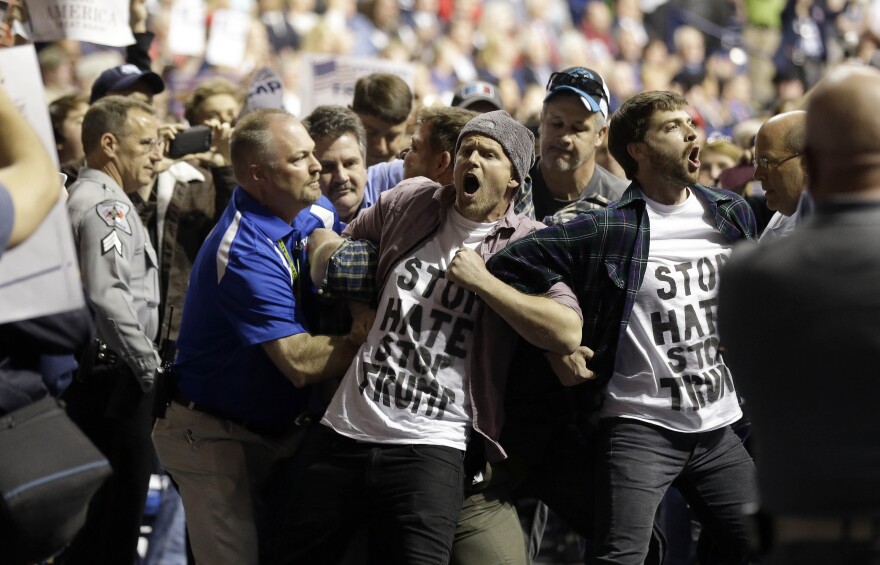 Protesters are removed as Republican presidential candidate Donald Trump speaks during a campaign rally in Fayetteville, N.C., Wednesday, March 9, 2016.