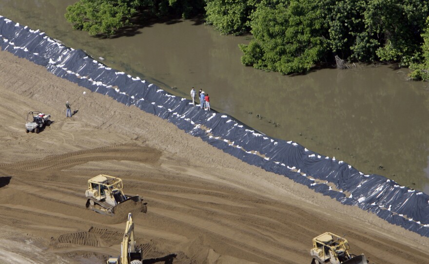 Crews push extra sand onto Mississippi River levees in the Sny drainage district in Illinois during a flood in June 2008.