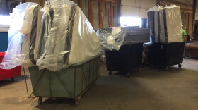 Mattresses line up at a loading dock. Volunteers continue furniture deliveries to families displaced by the Memorial Day Tornadoes.