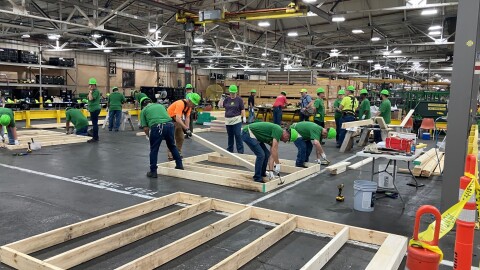 John Deere Harvester Works employees work on building wood frames for a Habitat for Humanity house at the East Moline plant, Friday, May 29, 2026.