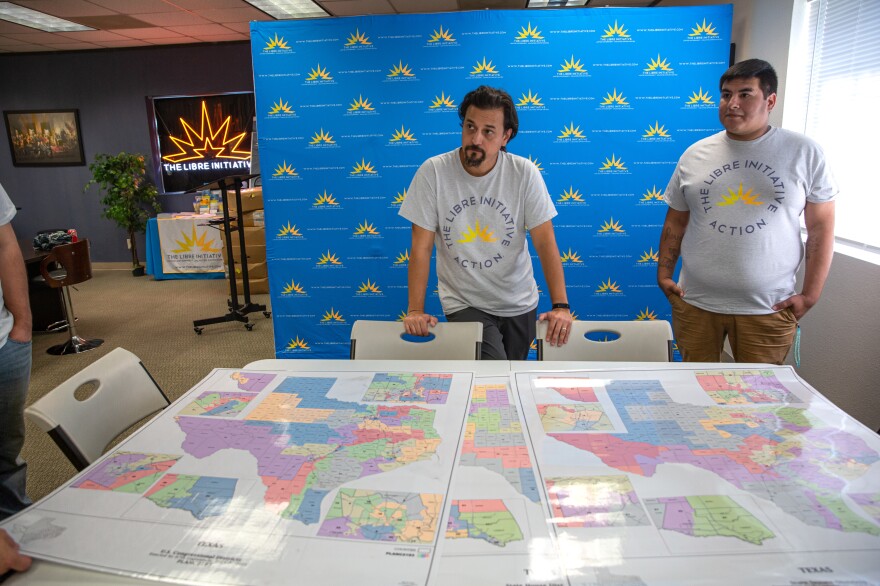 Johnny Vasquez of LIBRE displays district maps in their office in McAllen, Texas, on Oct. 5.