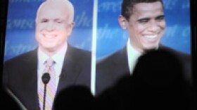 Democratic supporters watch Sen. Barack Obama, right, and Sen. John McCain on Friday during the first presidential debate.