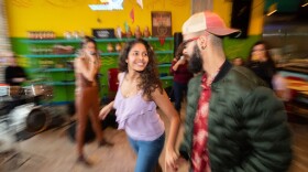 Cristina Vega, 28, left, dances cumbia with Giancarlo Rinaldini, 24, during a performance by cumbia group Sabor Puro, at La Pesca Market on Jefferson Boulevard in Dallas, on Sunday, Jan. 15, 2023.