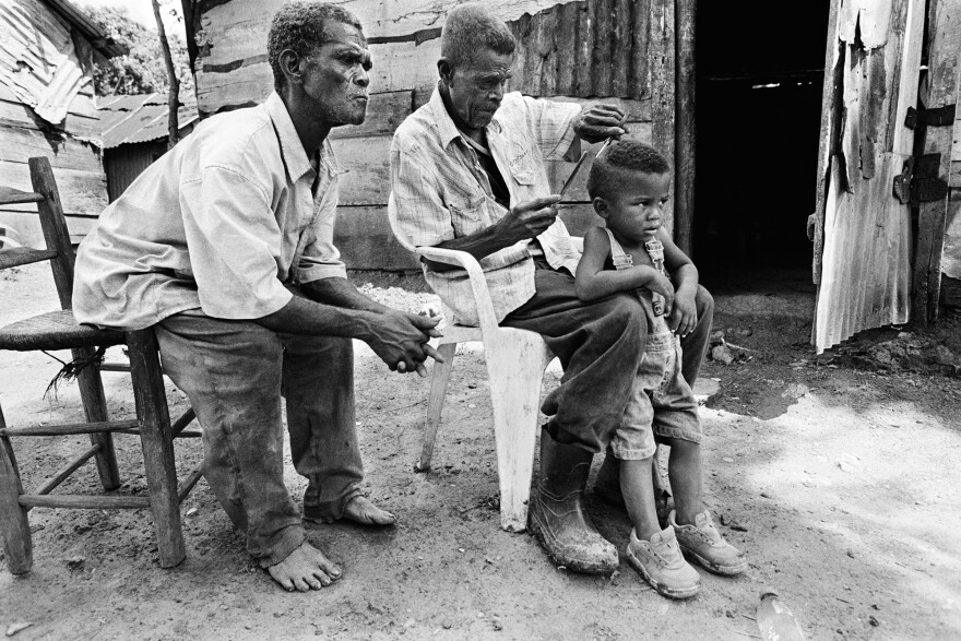 In the Dominican Republic, 92-year-old Julien cuts the hair of a 3-year-old. The boy was born in the DR but denied a birth certificate because his parents are of Haitian descent, says Constantine.