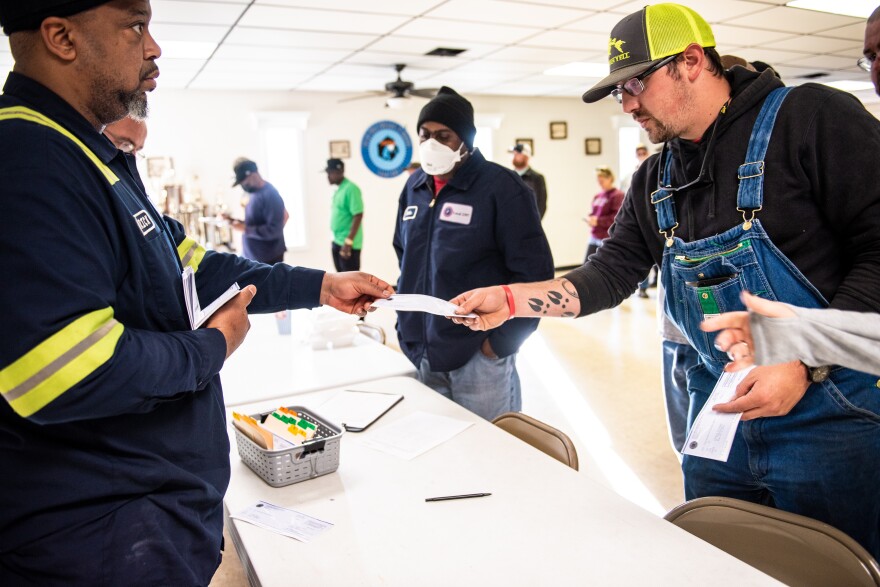 Striking coal miners pick up their strike checks from the United Mine Workers of America at a union hall on March 23, 2022, in Brookwood, Alabama.