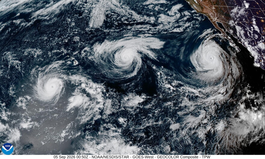 A satellite image shows from left to right, Hurricane Lowell, Hurricane Karina and Hurricane Marie in the Pacific on Friday afternoon.