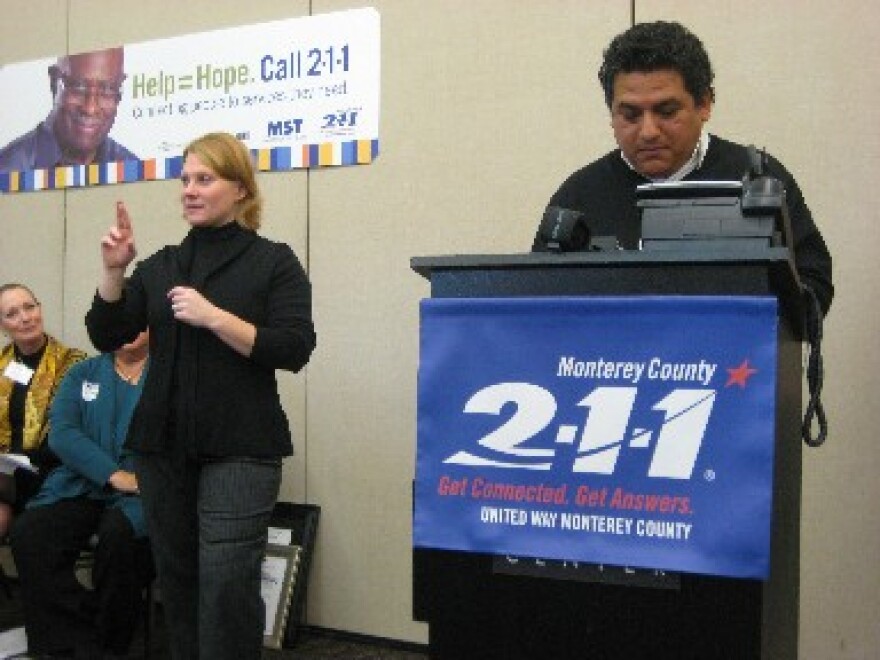 Salinas City Councilman Sergio Sanchez places the first call to the Monterey County 211 line.