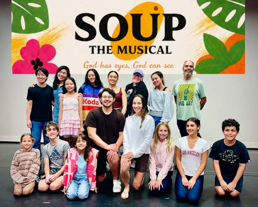 The cast of Soup The Musical poses on stage.