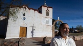 Isaac Melendrez Jr. sits in front of Our Lady of Purification Catholic Church in Doña Ana, N.M., on March 15, 2026. Melendrez lives only a mile from the church, where he was sexually abused by the priest as a child, but still avoids the immediate area.