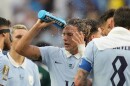 Uruguay’s Agustin Canobbio cools off during a hydration break during a match with Saudi Arabia on June 15.