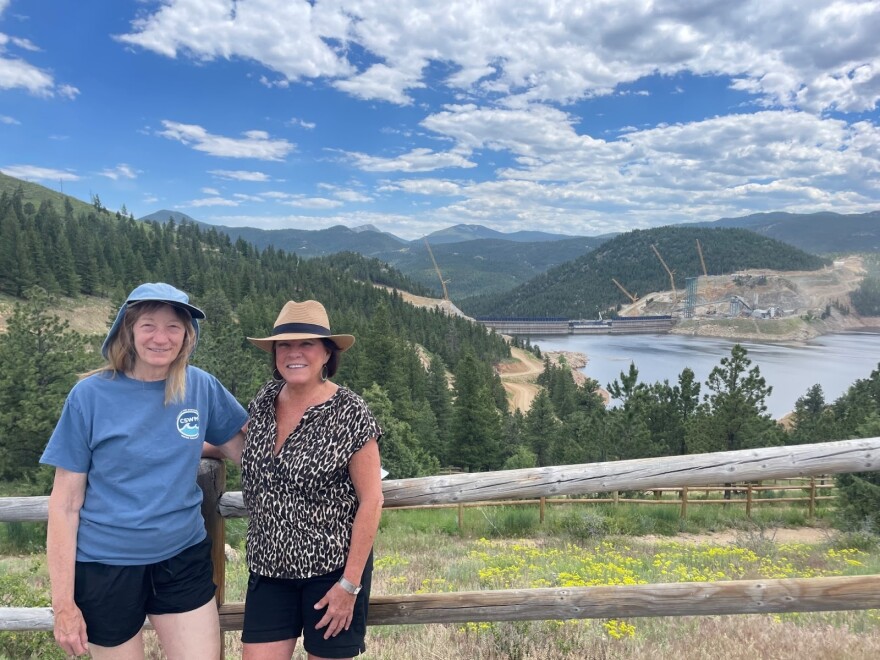 Beverly Kurtz and Anna McDermott, longtime residents of the Lakeshore Park neighborhood pose in front of Gross Reservoir on June 19, 2025. They are members of TEG, an environmental group involved in a lawsuit against Denver Water.