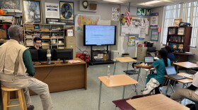 C.B. Hanif's classroom at Inlet Grove Community High School, where student reporters are combining their articles into one story. Hanif, left, offers nuggets of wisdom, like: "Editorial writing is the art of knowing what to leave out."