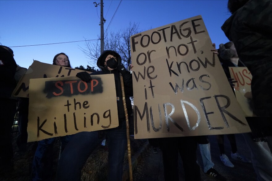 Protesters hold signs Friday, Jan. 27, 2023, in Memphis, Tenn., as authorities are set to release police video depicting five Memphis officers beating Tyre Nichols, whose death resulted in murder charges and provoked outrage at the country's latest instance of police brutality.