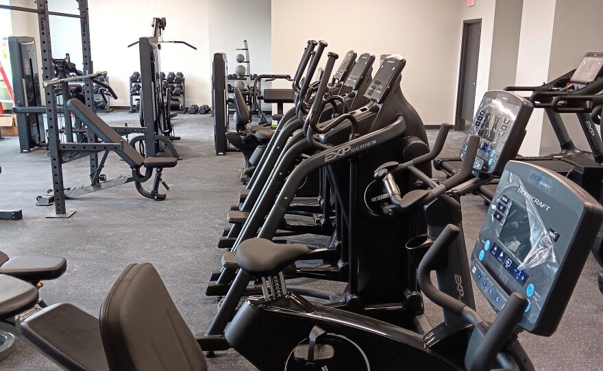 Exercise equipment available in a gym room which overlook the turf field in the new Kenan Civic Center.