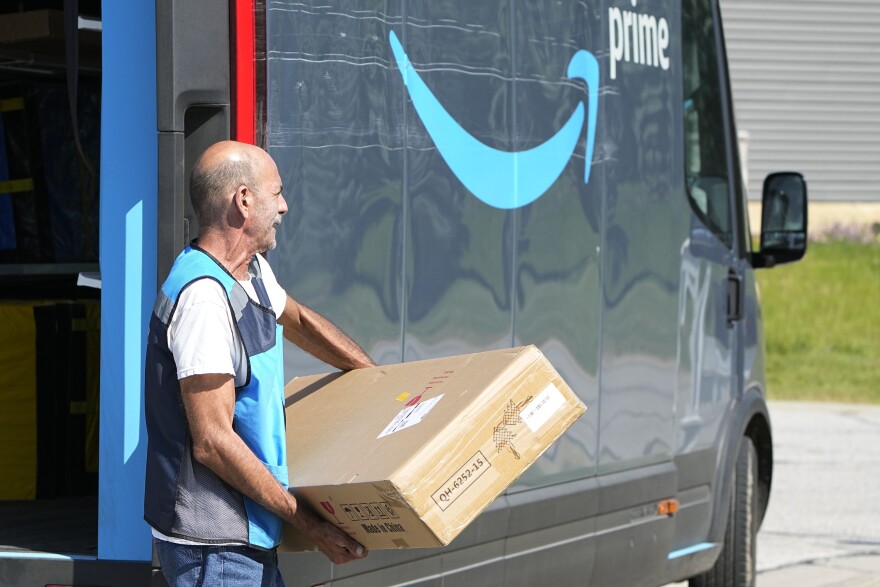 Philip Becar delivers a package for Amazon Thursday, June 1, 2023, in Sagamore Hills, Ohio. (AP Photo/Sue Ogrocki)