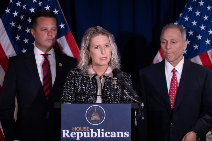 Rep. Jen Kiggans, R-Va., center, accompanied by Rep. Zachary Nunn, R-Iowa, left, and House Majority Leader Steve Scalise, R-La., right, speaks at a news conference at the Republican National Committee headquarters on Capitol Hill, in Washington, Wednesday, Sept. 18, 2024
