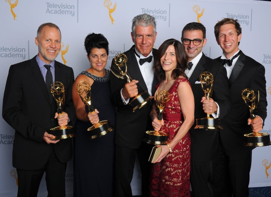 Chris Collins, from left, Lydia Tenaglia, Anthony Bourdain, Sandra Zweig, Tom Vitale and Erik Osterholm, winners of the award for outstanding informational series or special for "Anthony Bourdain: Parts Unknown," pose for a portrait at the Television Academy's Creative Arts Emmy Awards on Sept. 12, 2015, in Los Angeles. (Vince Bucci/Invision for the Television Academy/AP)