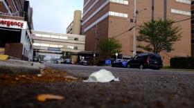 In a file photo, a face mask lies on the ground outside Ochsner Baptist during New Orleans' first wave of the pandemic.