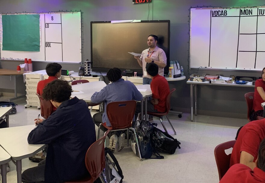 Teacher in front of class of 8th graders