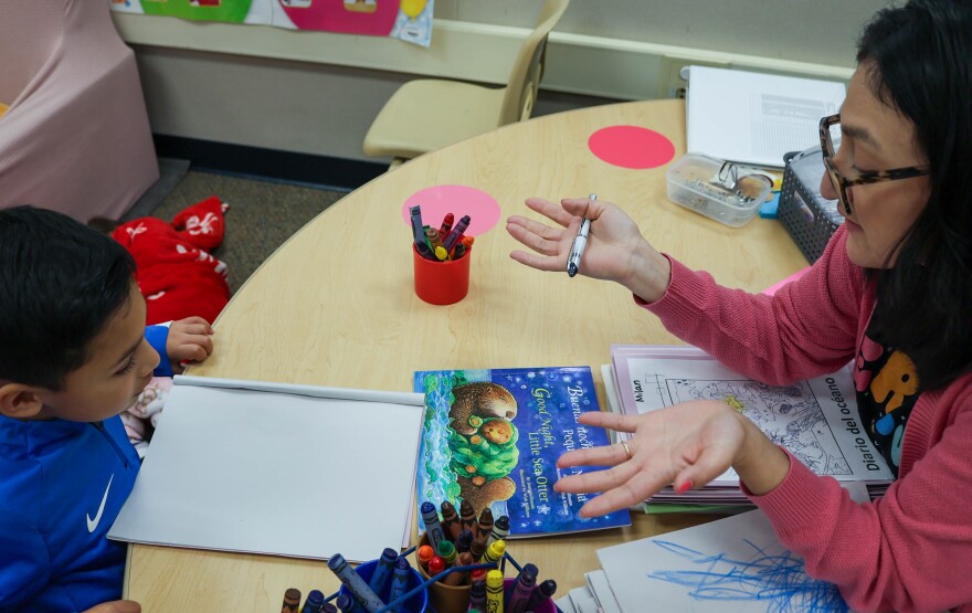 TK teacher Beatriz Amador speaks with a student in Spanish about an otter’s body.