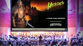 An orchestra plays while an image from The Elder Scrolls IV: Oblivion is on the screen above it. 