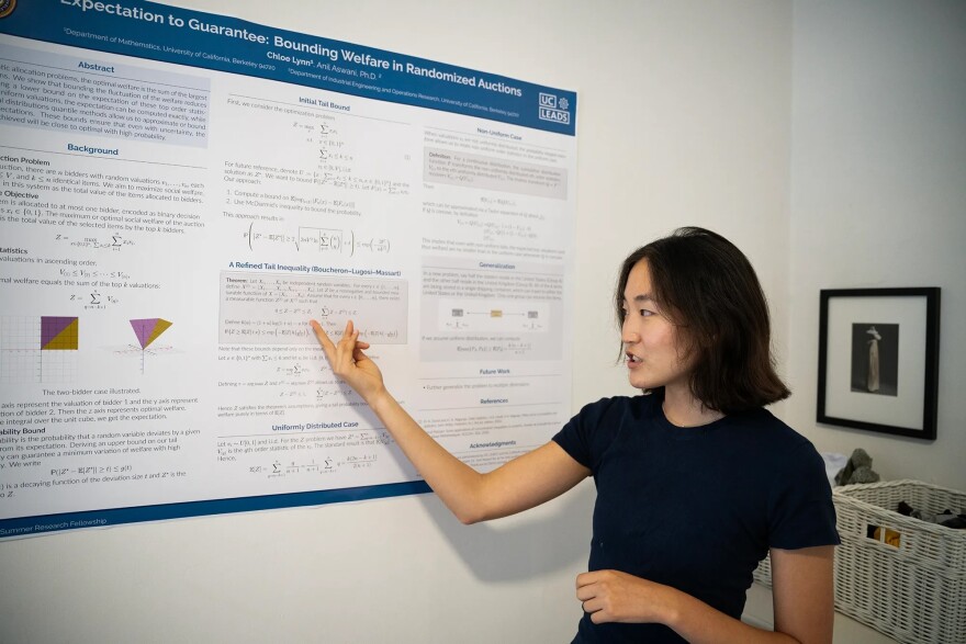 Chloe Lynn, 20, a UC Berkeley undergraduate student double majoring in applied mathematics and operations research and management science, at her home in Berkeley on Aug. 5, 2025. Lynn recently presented a poster for her project in optimization theory that she keeps displayed on her bedroom wall.