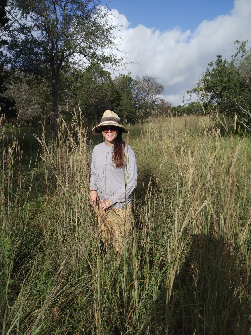 Wendy Leonard, a Nature Preserve Officer for the San Antonio Parks department, poses by of one of her favorite grasses — big bluestem.