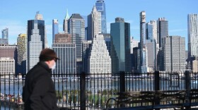 A man wearing a face mask takes a walk on the Brooklyn Heights Promenade on March 24, 2020 in New York. (Angela Weiss/AFP/Getty Images)