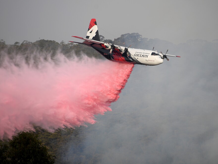 An air tanker operated by Canada-based Coulson Aviation drops fire retardant on the Morton Fire burning in bushland close to homes at Penrose, south of Sydney, earlier this month.