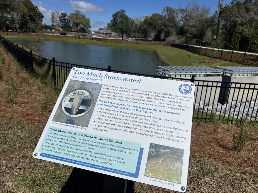 An informational sign explains how stormwater is filtered at Carpenter Creek Headwaters Park, including the use of hydrodynamic separators that help remove pollutants before water flows into the creek.